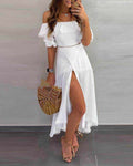 Woman wearing white off shoulder half sleeve ankle-length patchwork cotton dress with slit and holding wooden handbag